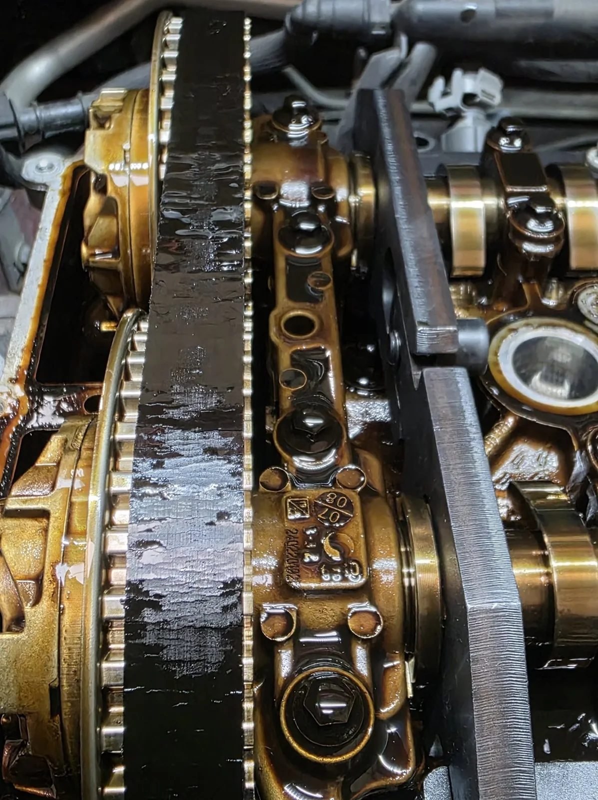 Close-up of a vehicle timing belt and engine components
